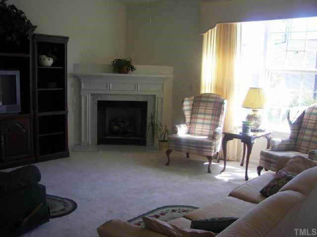 10470 Dapping Drive Raleigh, NC 27614 - Photo 3 of 8 a living room with furniture and a fireplace