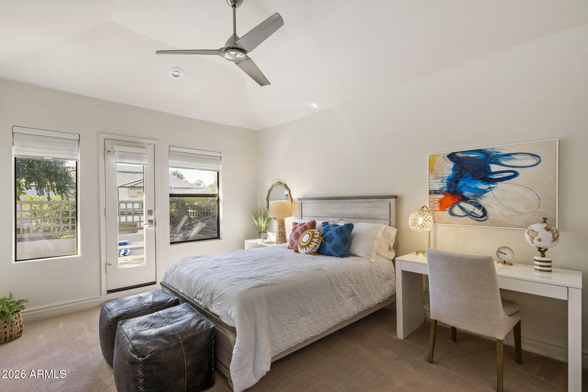 7272 East Gainey Ranch Road, Unit 12 Scottsdale, AZ 85258 - Photo 17 of 28 a bedroom with a bed and wooden floor