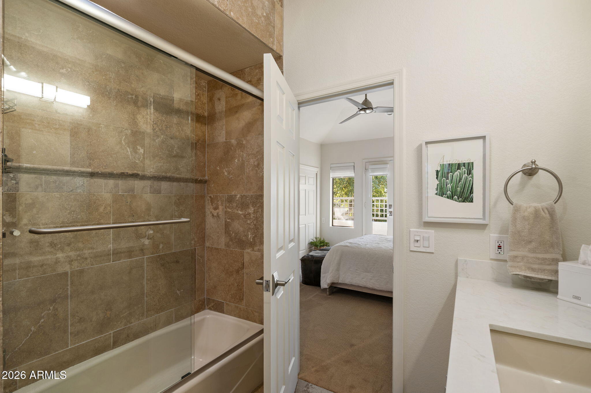 7272 East Gainey Ranch Road, Unit 12 Scottsdale, AZ 85258 - Photo 18 of 28 a en suite bathroom with a tub shower and sink