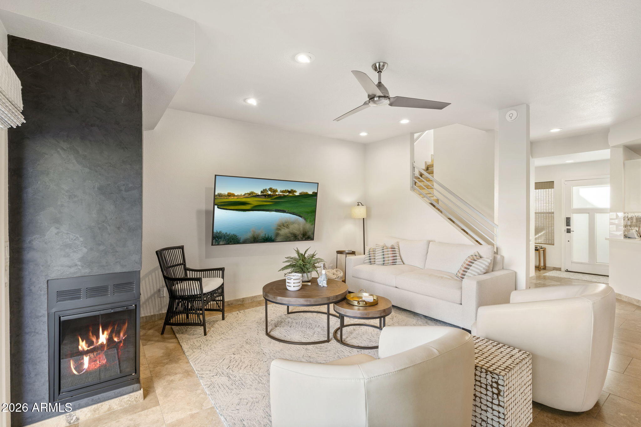 7272 East Gainey Ranch Road, Unit 12 Scottsdale, AZ 85258 - Photo 2 of 28 a living room with furniture and a fireplace