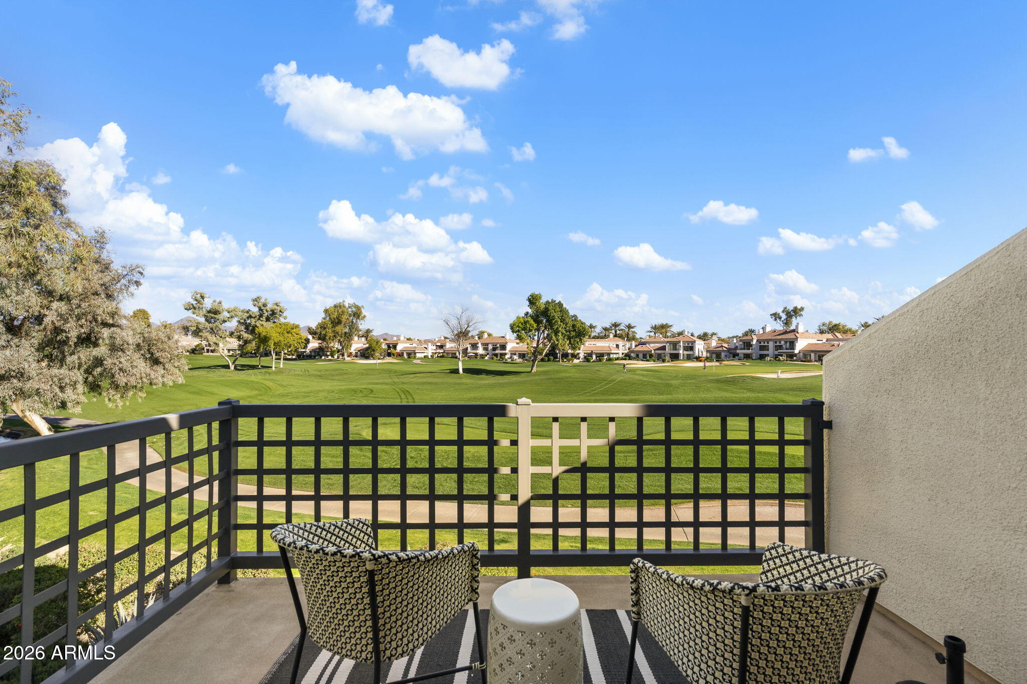 7272 East Gainey Ranch Road, Unit 12 Scottsdale, AZ 85258 - Photo 21 of 28 a view of a chairs and table in the patio