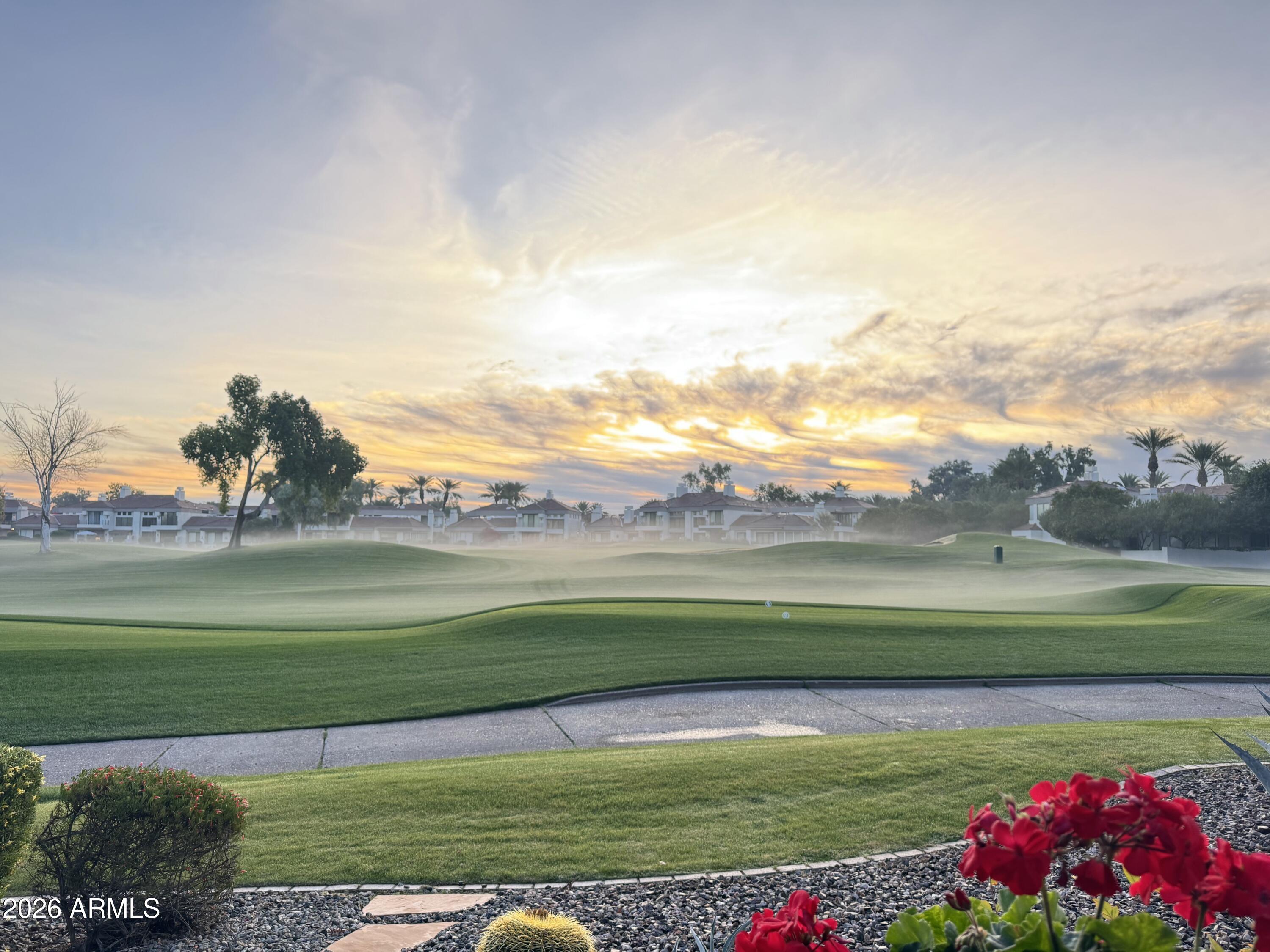 7272 East Gainey Ranch Road, Unit 12 Scottsdale, AZ 85258 - Photo 23 of 28 a view of a golf course with a lake