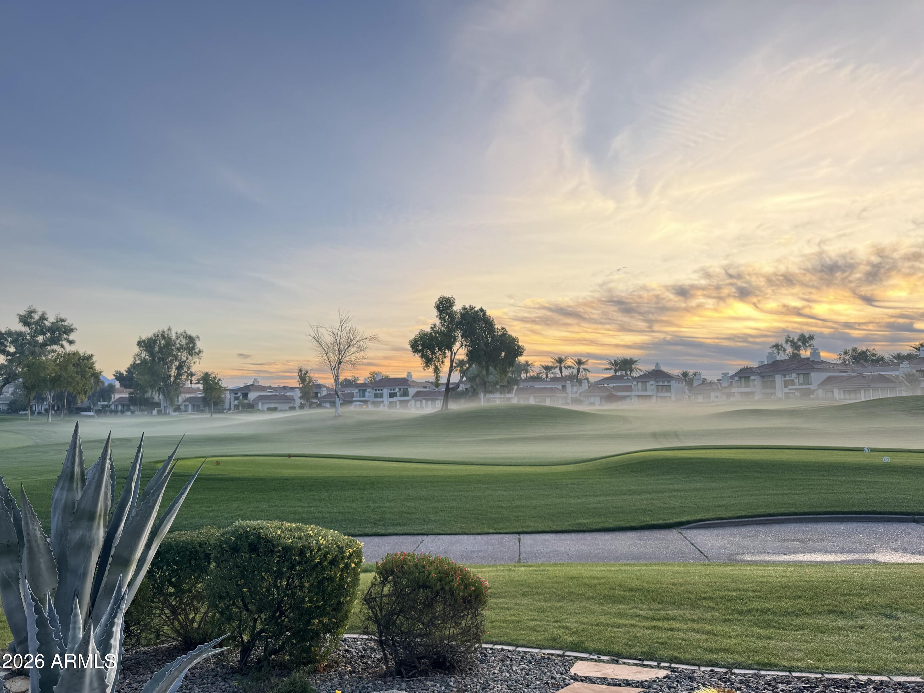 7272 East Gainey Ranch Road, Unit 12 Scottsdale, AZ 85258 - Photo 24 of 28 a view of a golf course with a lake