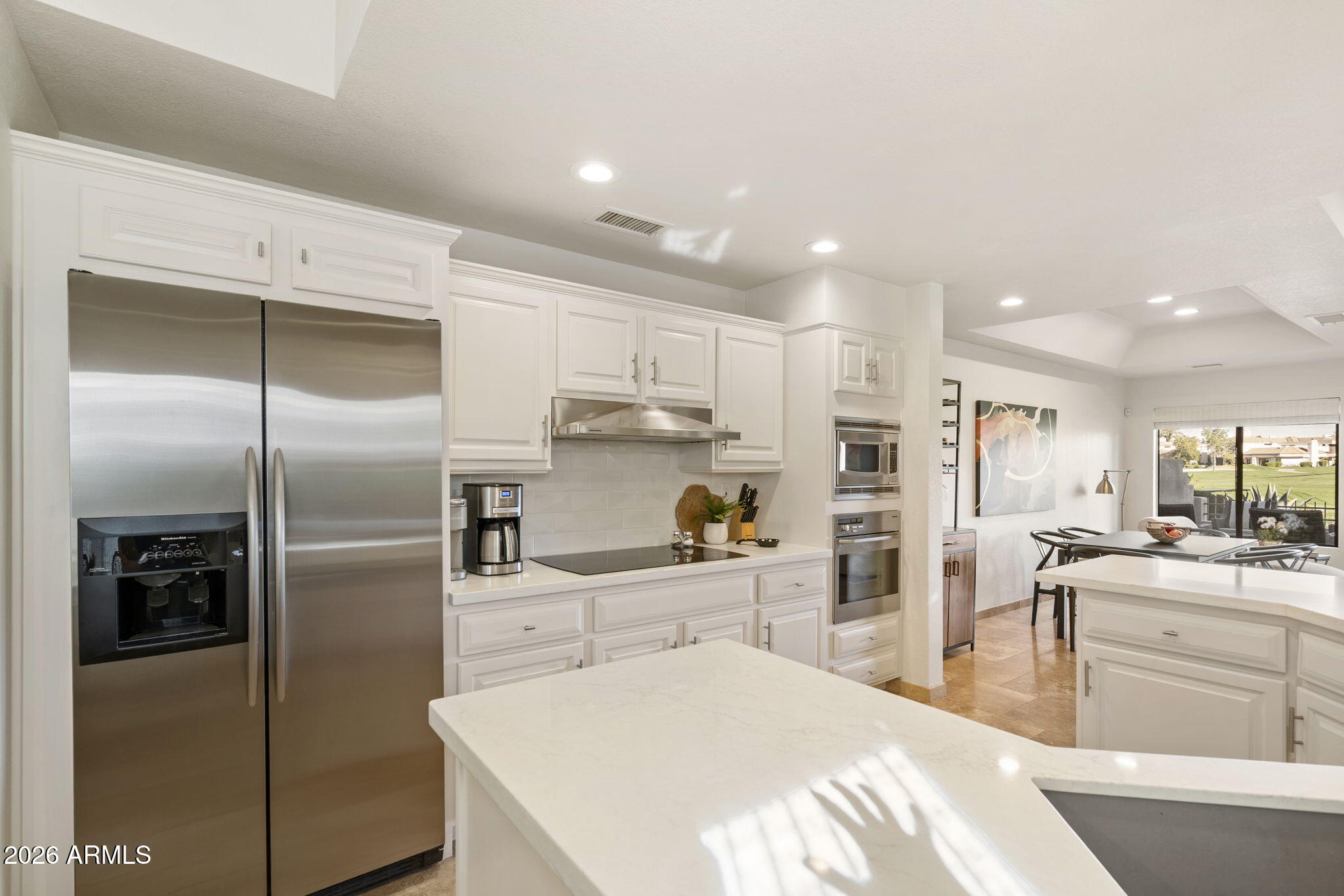 7272 East Gainey Ranch Road, Unit 12 Scottsdale, AZ 85258 - Photo 9 of 28 a kitchen with a refrigerator and a sink