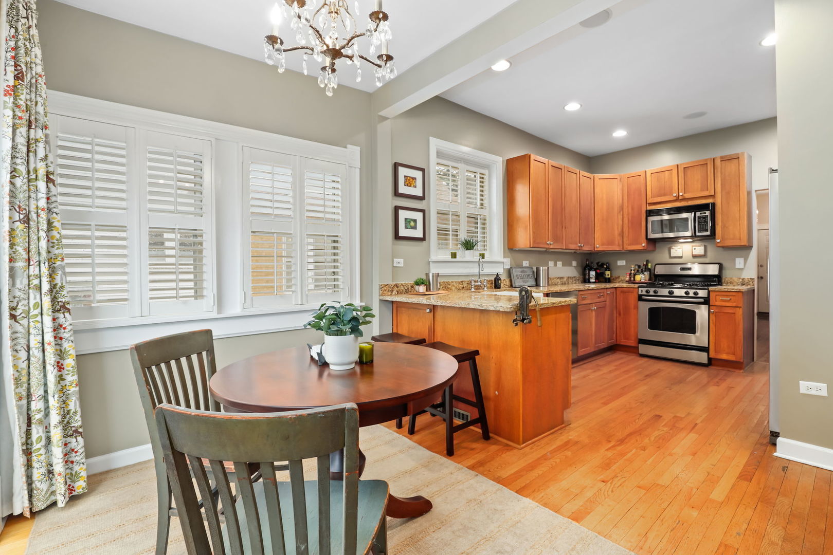 4232 North Tripp Avenue Chicago, IL 60641 - Photo 17 of 46 a kitchen with stainless steel appliances granite countertop a stove a sink a microwave dining table and chairs
