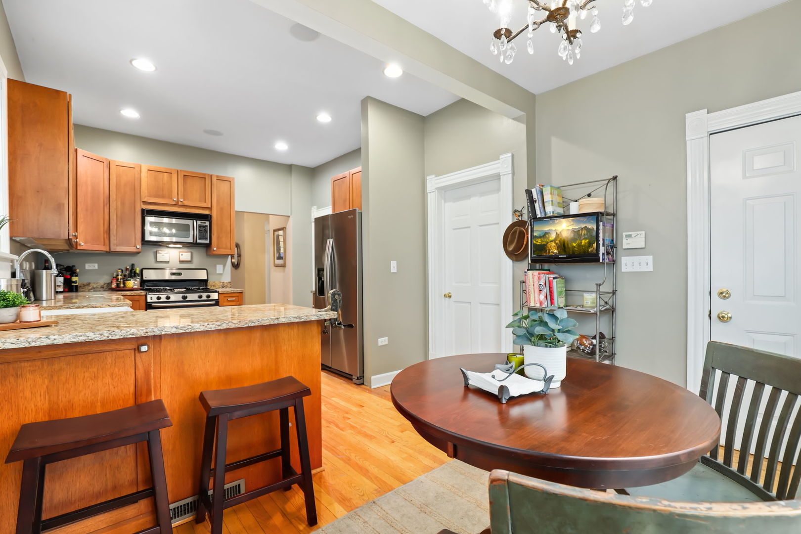 4232 North Tripp Avenue Chicago, IL 60641 - Photo 19 of 46 a kitchen with sink a refrigerator and chairs