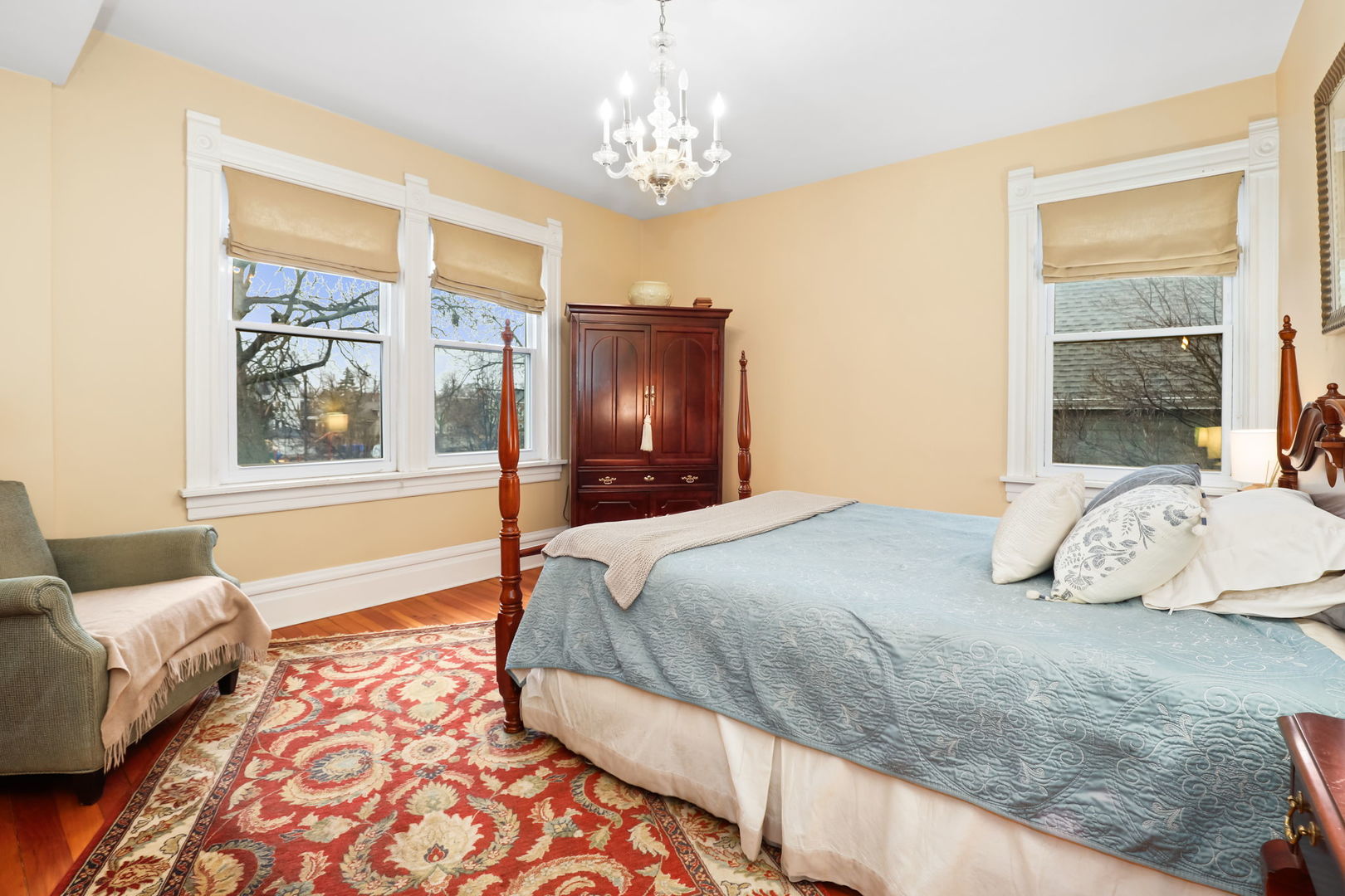 4232 North Tripp Avenue Chicago, IL 60641 - Photo 26 of 46 a bedroom with a large bed and a chandelier