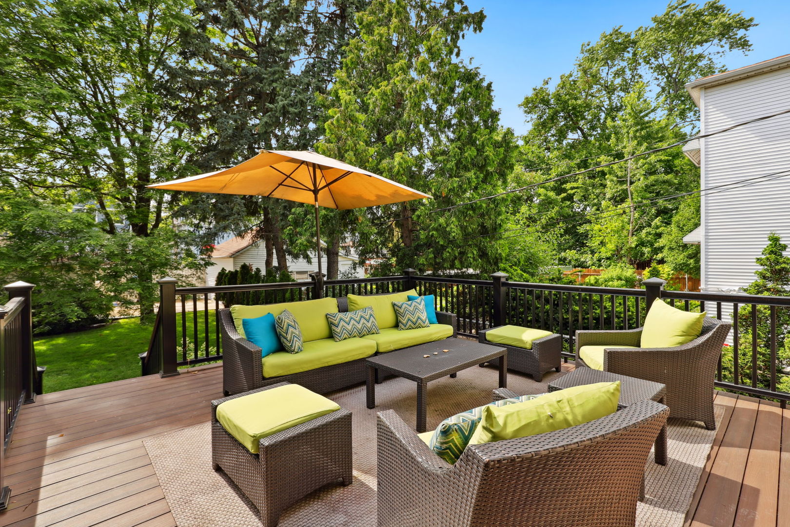 4232 North Tripp Avenue Chicago, IL 60641 - Photo 37 of 46 a view of a patio with couches chairs under an umbrella with a small yard