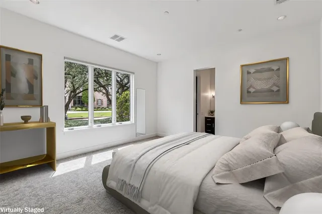 a bedroom with a bed and a large window