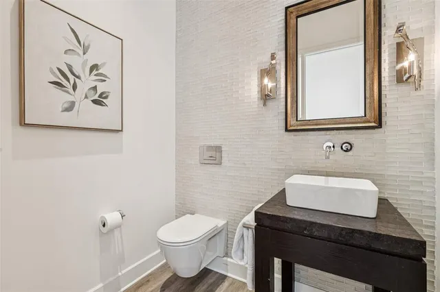 a bathroom with a toilet a sink and mirror