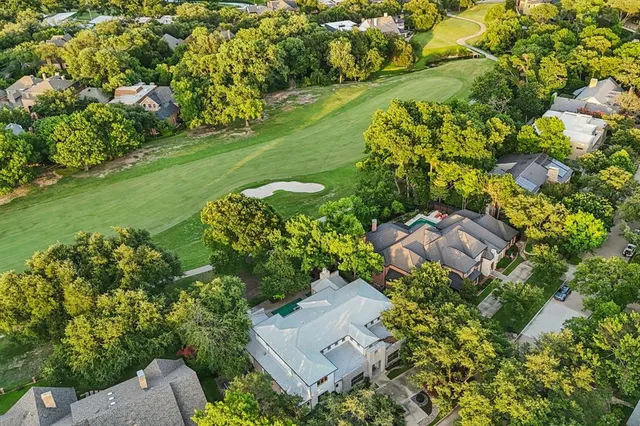 an aerial view of a house with a yard and lake view