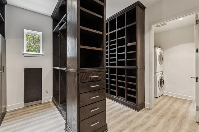a view of walk in closet with empty racks