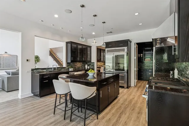 a kitchen with sink cabinets and wooden floor