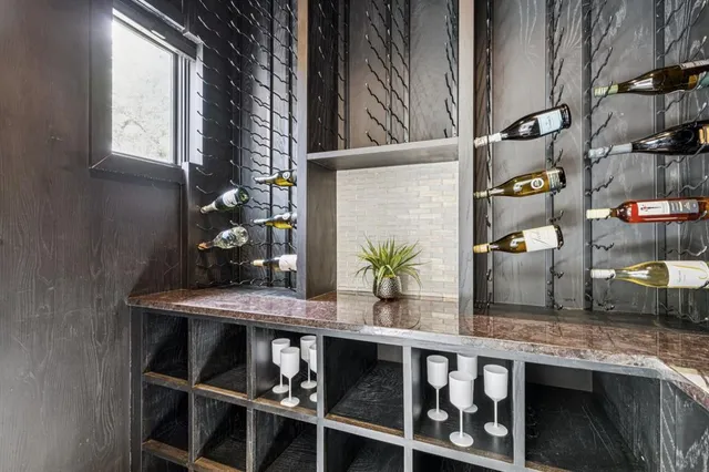 a table with wine bottles and glasses on it