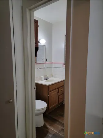 a bathroom with a sink toilet and mirror