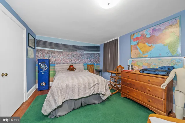 a bed sitting in a bedroom next to a window