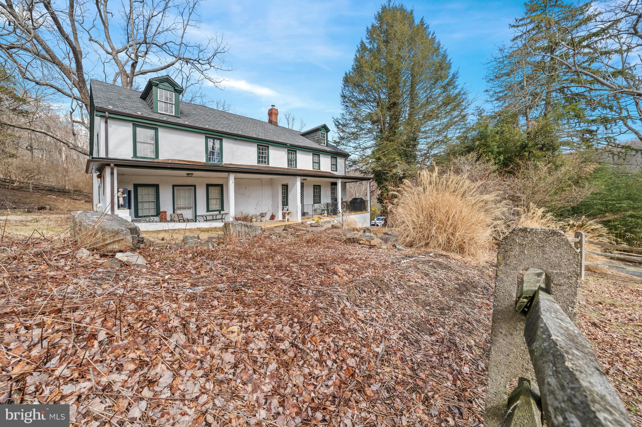 3934 Thompsons Bridge Road Wilmington, DE 19807 - Photo 19 of 28 a front view of a house with a garden and trees