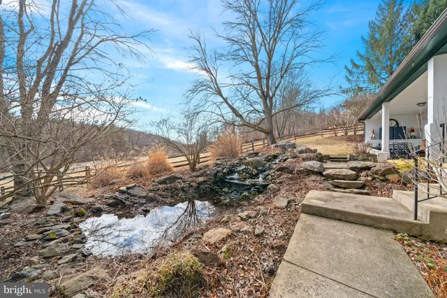a view of a house with a yard covered with snow in the background
