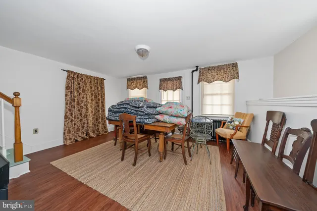 a dining room with furniture and wooden floor
