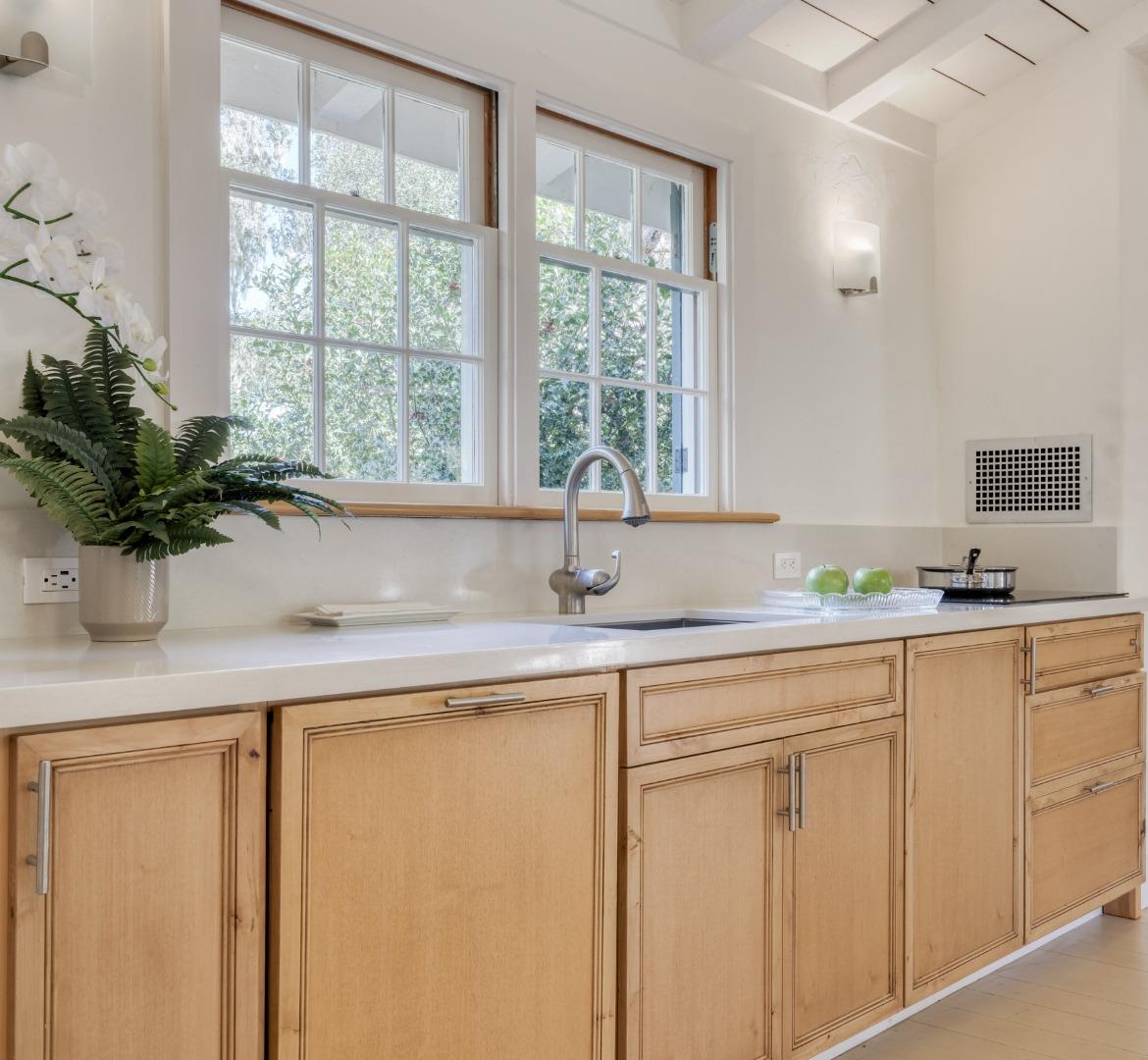 150 Littlefield Road Monterey, CA 93940 - Photo 28 of 51 a kitchen with white cabinets and a large window