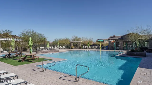 a swimming pool with outdoor seating and yard
