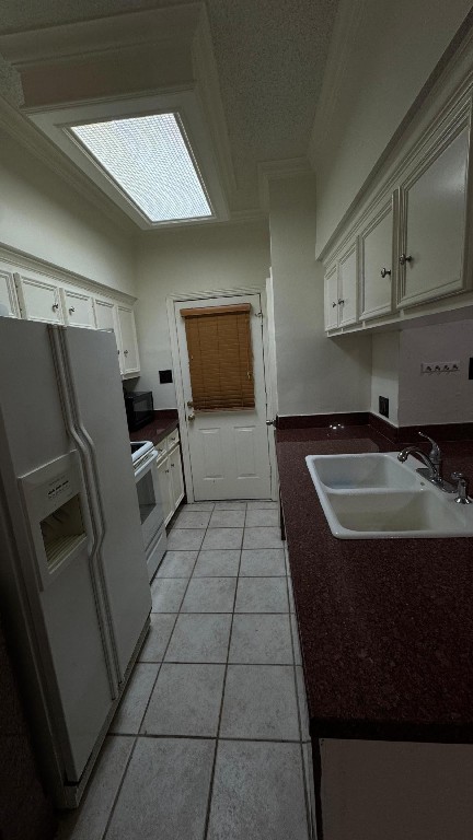 3600 Jeanetta Street, Unit 1301 Houston, TX 77063 - Photo 13 of 21 a kitchen with a sink a refrigerator and cabinets