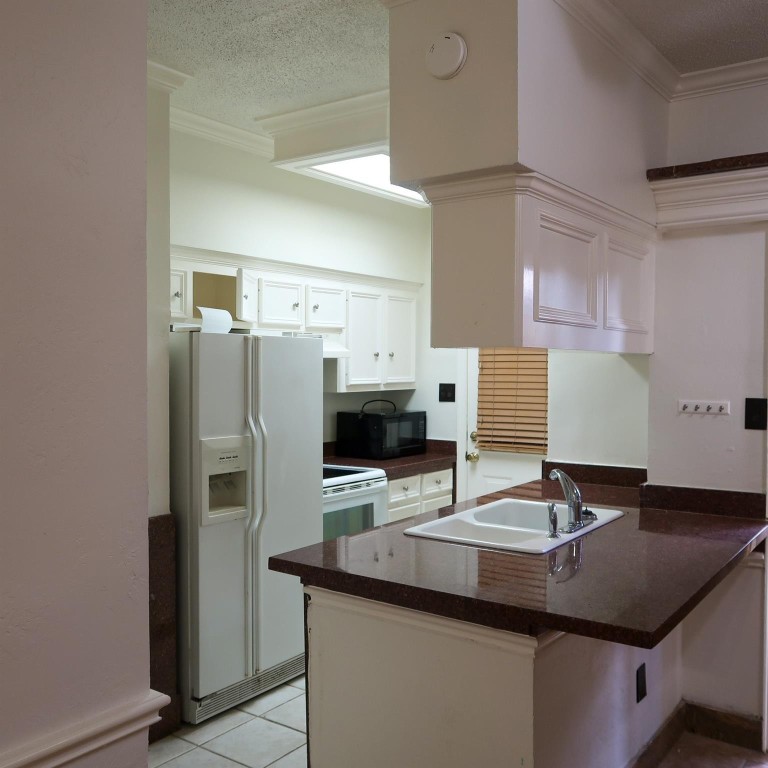 3600 Jeanetta Street, Unit 1301 Houston, TX 77063 - Photo 6 of 21 a kitchen with stainless steel appliances a sink and a refrigerator