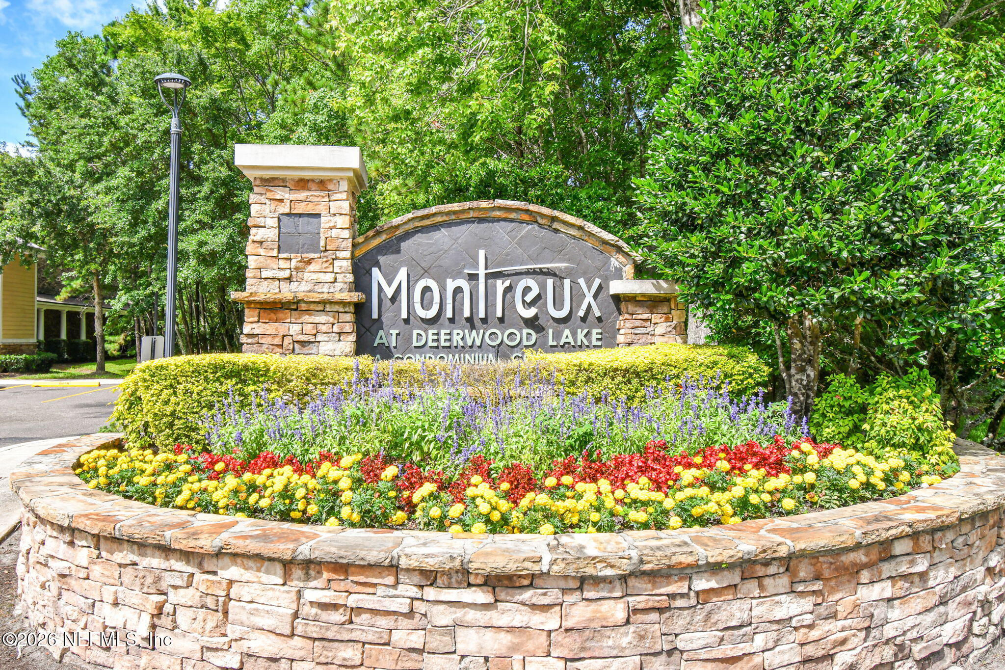 8550 Touchton Road, Unit 511 Jacksonville, FL 32216 - Photo 1 of 63 a sign that is sitting in front of flowers