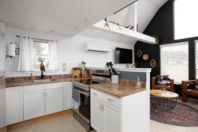 a kitchen with stainless steel appliances granite countertop a sink stove and cabinets
