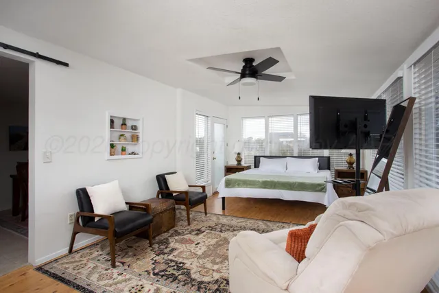 a living room with furniture wooden floor and a flat screen tv