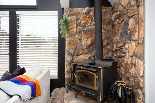 a bedroom with a bed and a fireplace