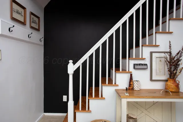 a view of staircase with wooden floor and a potted plant