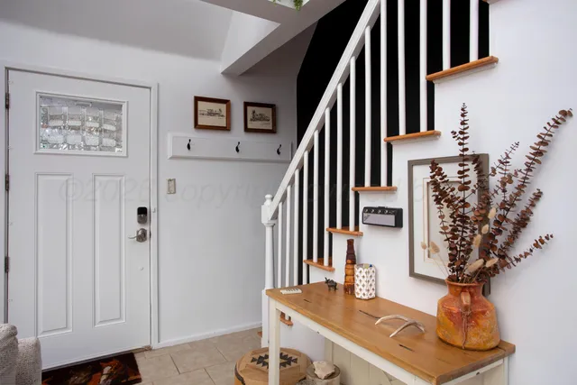 a view of hall way with furniture and staircase