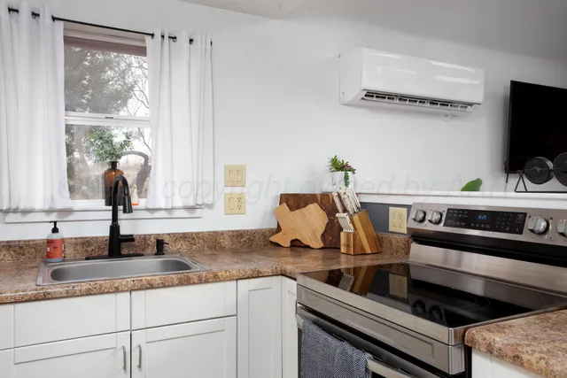 a kitchen with stainless steel appliances granite countertop a sink and a stove