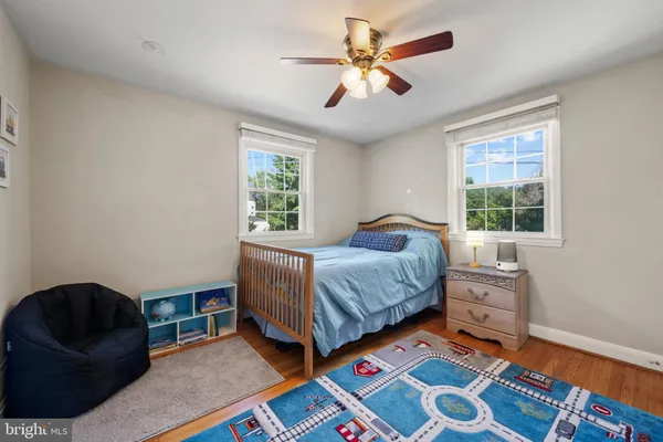 a living room with furniture and a baby crib