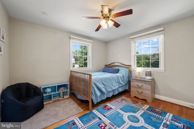 a living room with furniture and a baby crib