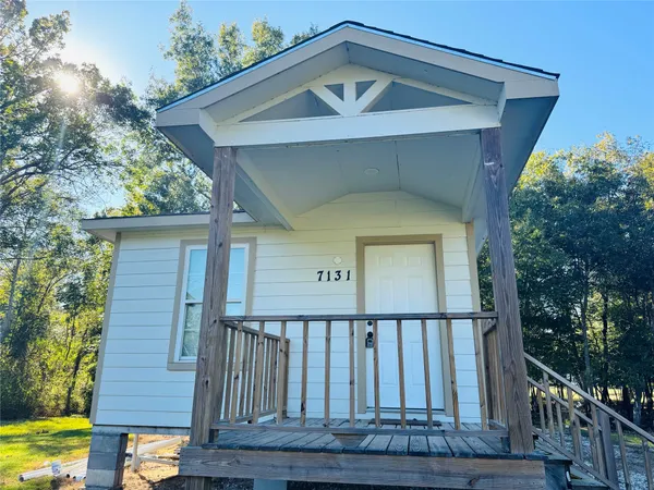 a front view of a house with wooden fence