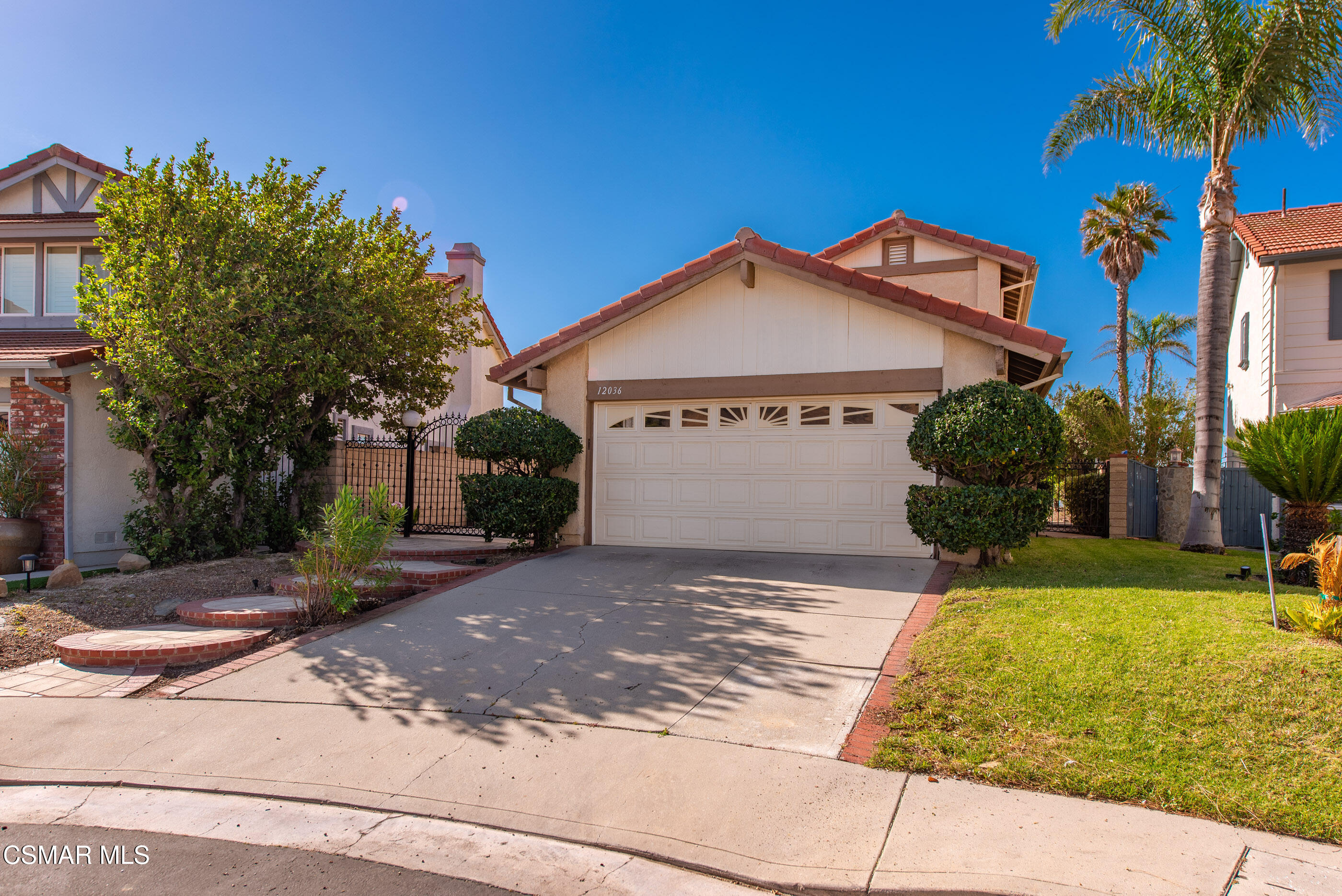 12036 Shadow Ridge Way Porter Ranch, CA 91326 - Photo 1 of 35 a front view of a house with a yard and garage