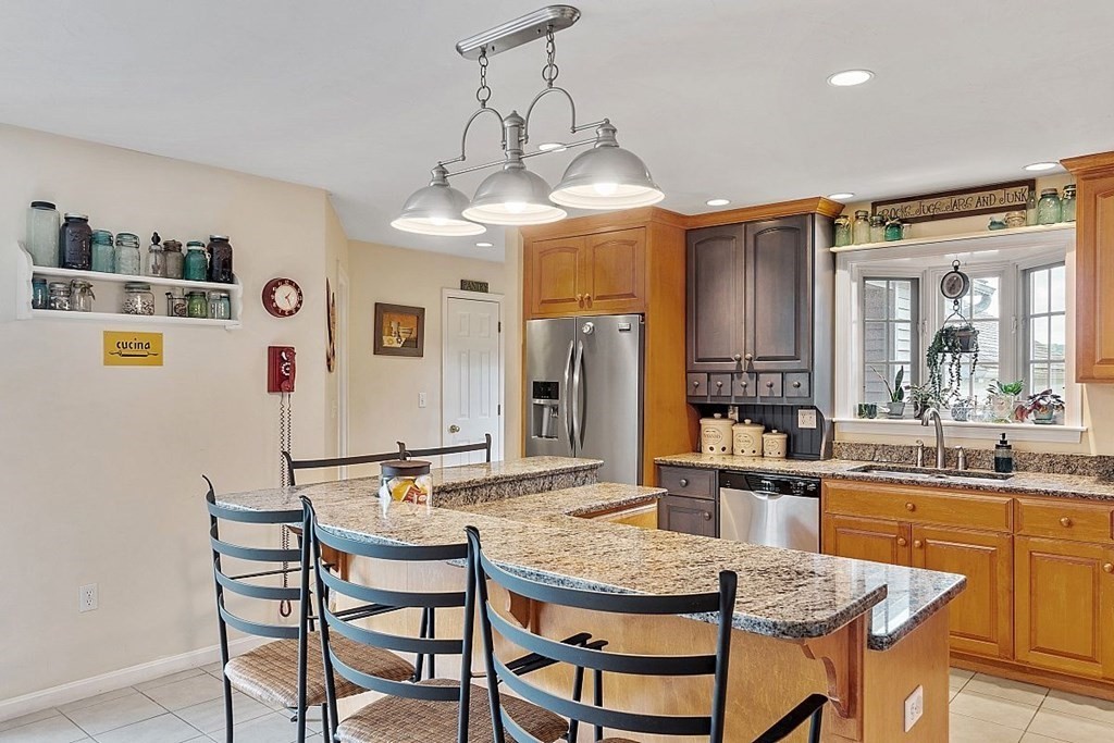 299 South Meadow Road Lancaster, MA 01523 - Photo 19 of 41 a dining room filled a chandelier and kitchen view