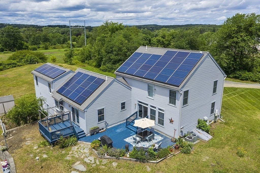 299 South Meadow Road Lancaster, MA 01523 - Photo 2 of 41 a aerial view of a house with a yard table and chairs