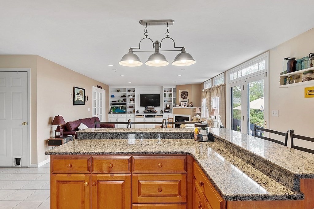 299 South Meadow Road Lancaster, MA 01523 - Photo 22 of 41 a kitchen with stainless steel appliances granite countertop a sink and cabinets