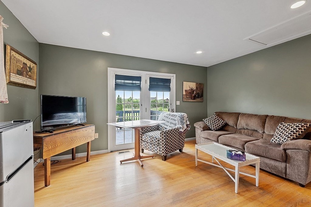 299 South Meadow Road Lancaster, MA 01523 - Photo 25 of 41 a living room with furniture and a flat screen tv
