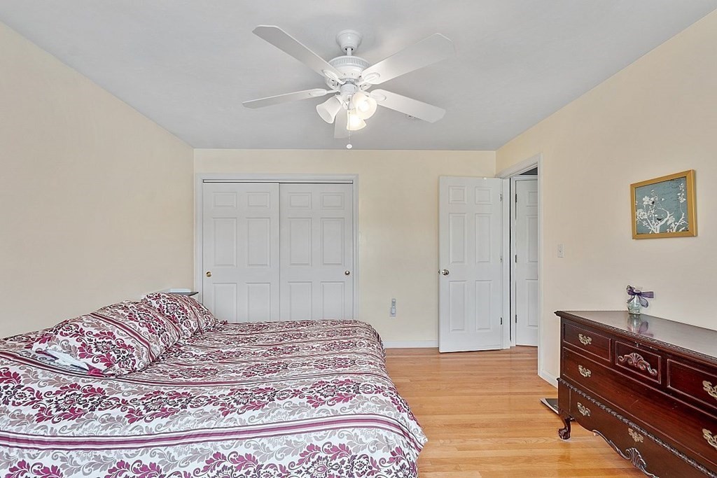 299 South Meadow Road Lancaster, MA 01523 - Photo 26 of 41 a bedroom with a bed and a dresser with wooden floor