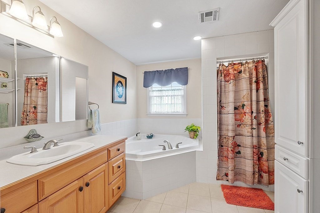 299 South Meadow Road Lancaster, MA 01523 - Photo 32 of 41 a bathroom with a tub sink and mirror