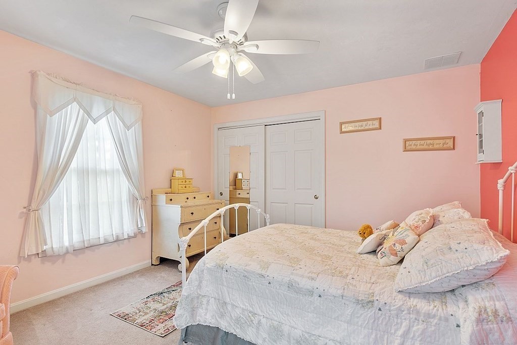 299 South Meadow Road Lancaster, MA 01523 - Photo 38 of 41 a bedroom with a bed and a chandelier