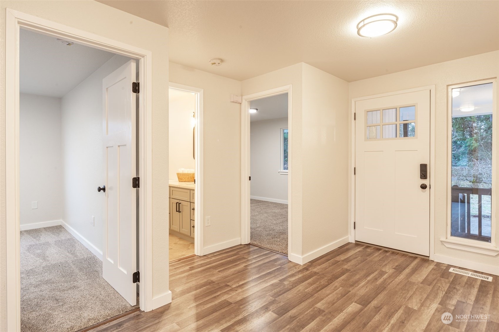 6742 187th Avenue Southwest Rochester, WA 98579 - Photo 3 of 27 an empty room with wooden floor and windows