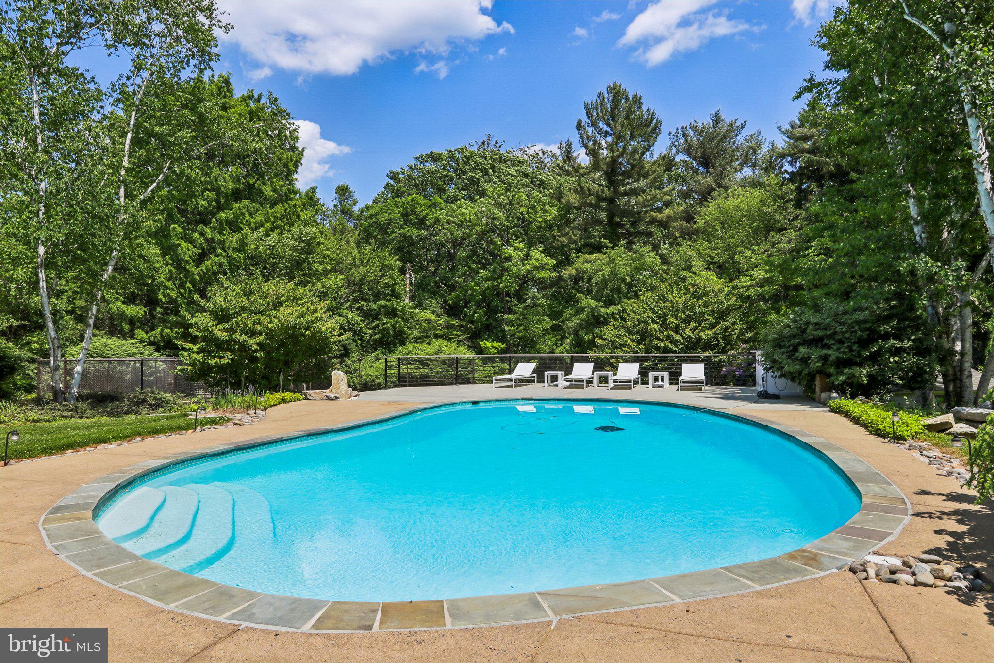 1673 Paper Mill Road Jenkintown, PA 19046 - Photo 66 of 73 a view of a swimming pool with an outdoor space and seating area
