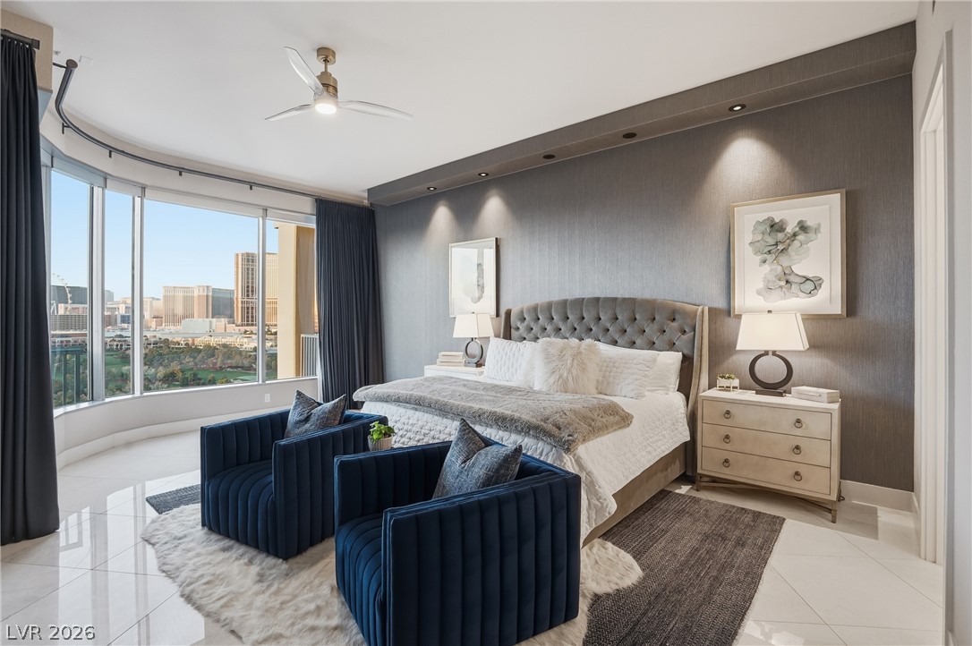 360 East Desert Inn Road, Unit 1701 Las Vegas, NV 89109 - Photo 18 of 33 City views frame this bedroom's elegant design, boasting high ceilings and tile flooring.