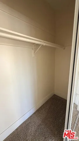 a view of living room with furniture and a mirror