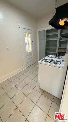 a room with a stove and a microwave